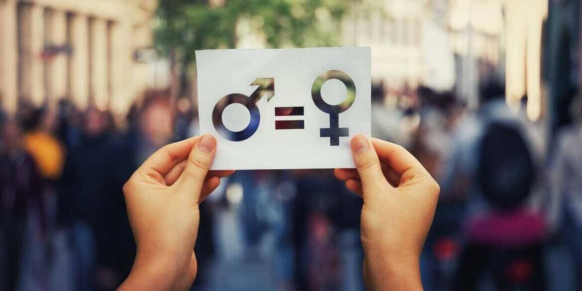 Mani che tengono manifesto di parità di genere